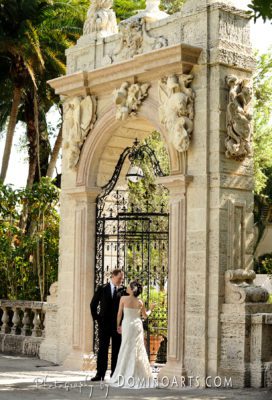 Bride and groom await at the forecourt gates.