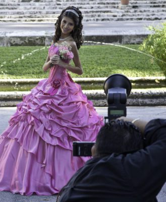 Young lady in pink ballgown having her photo taken at Vizcaya for her quinceañera.