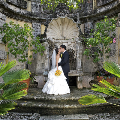 Bride and groom sneak a kiss in the Secret Garden.