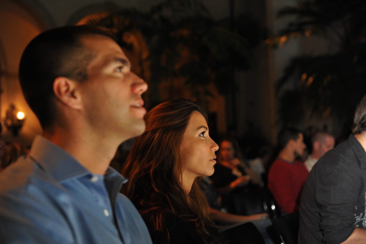 Man and woman watching a movie in the courtyard