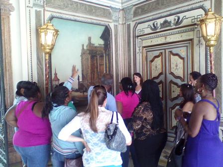 Group of university students in the Enclosed Loggia during a tour of Vizcaya.