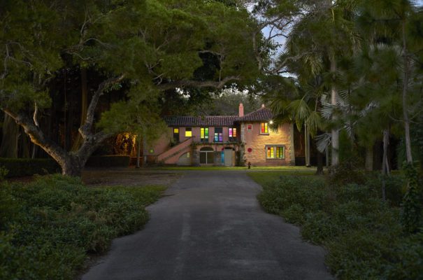 The Staff Residence in Vizcaya Village, with windows illuminated in colors as part of a 2017 Contemporary Arts Program installation by David Almeida.