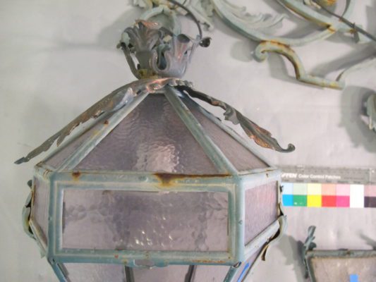 Light fixture during assessment with a color bar to determine tint of glass elements.
