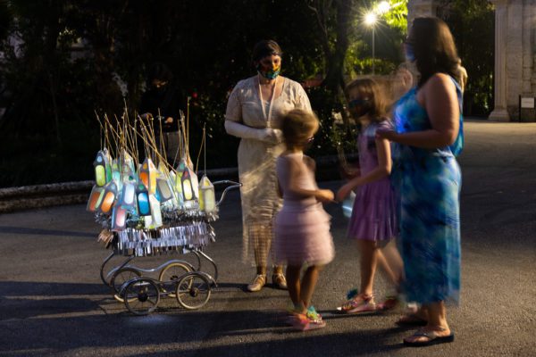 Guests pick up lanterns from cast memebrs during Spectral Vizcaya