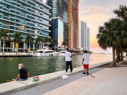 Men fishing on a canal in downtown Miami