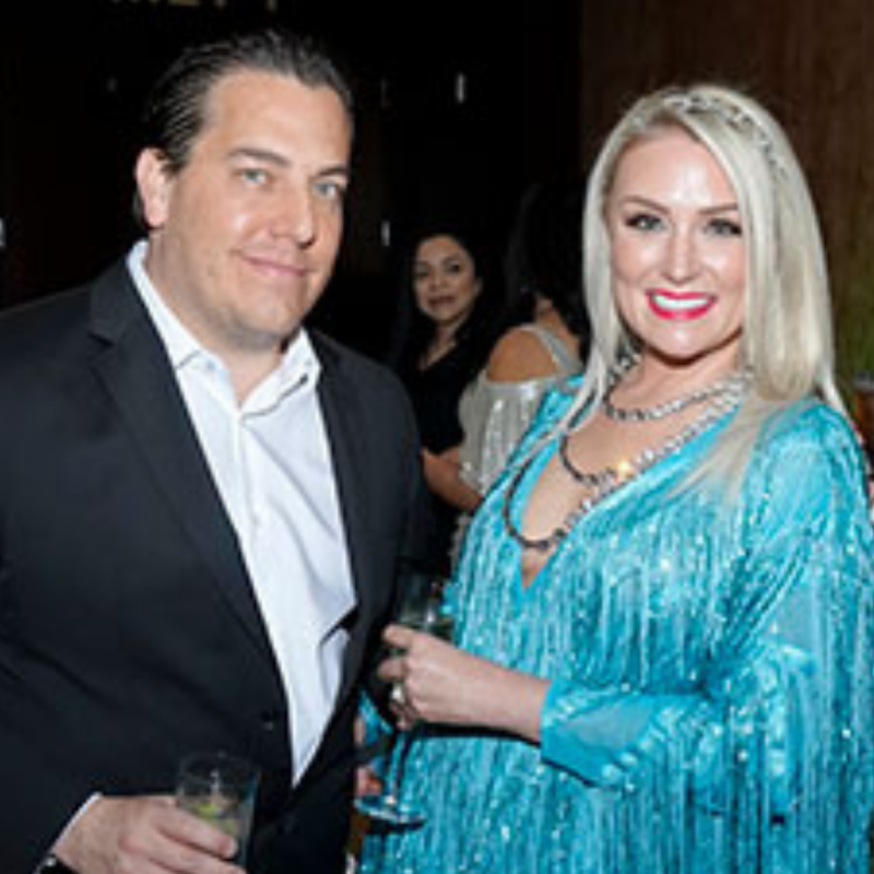 Gentleman in a suit and a beautiful blonde lady in a blue sequence and fringe dress