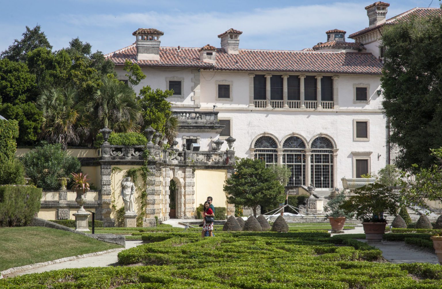 View of South Terrace of Vizcaya Museum and Gardens with green parterres in the foreground.