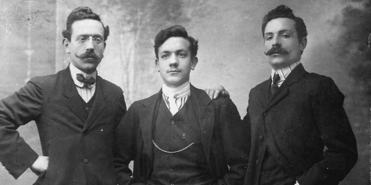 Black and white photo of three men dressed in 1920s attire