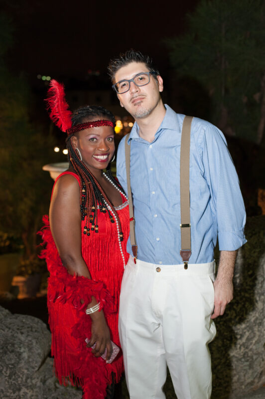 A woman in a red flapper dress and a man in suspenders ready for the Seeruscker Social