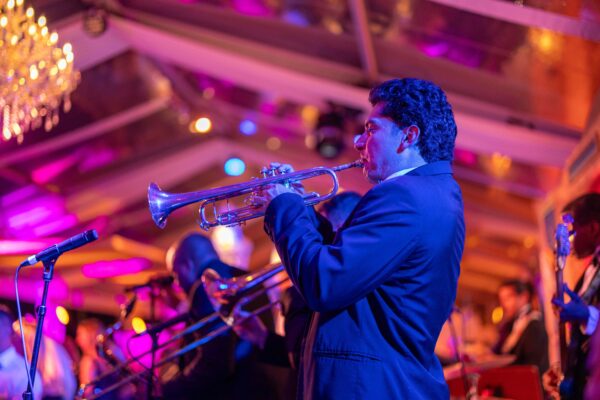 A man in a suit playing a trumpet at a Vizcaya Ball.