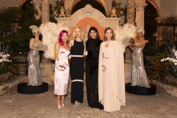 A group of women posing for a photo in front of the Vizcaya Ball statue.