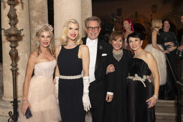 A group of people posing for a photo at the Vizcaya Ball, a formal event.