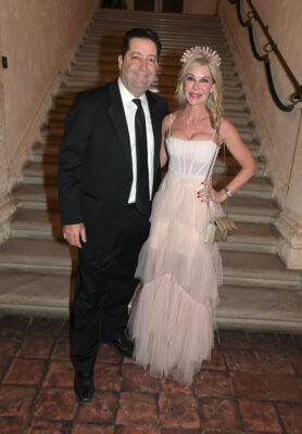 A man and woman in a formal dress standing at the Vizcaya Ball staircase.