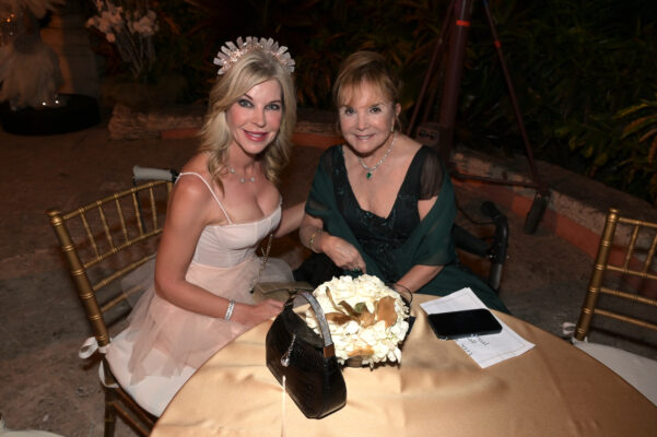 Two women sitting at a Vizcaya Ball table.