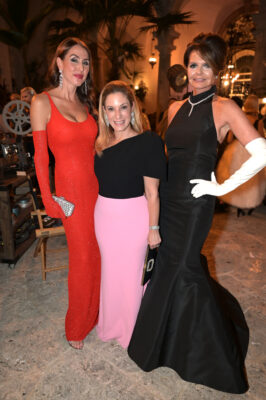 Three women in gowns posing for a picture at the Vizcaya Ball.