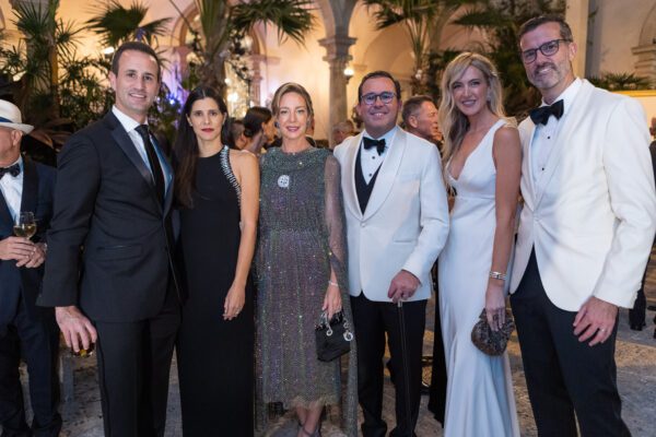 A group of people in tuxedos posing for a photo at the Vizcaya Ball.