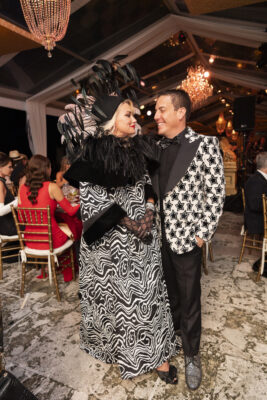 A man and woman in a zebra print dress standing next to each other at the Vizcaya Ball.