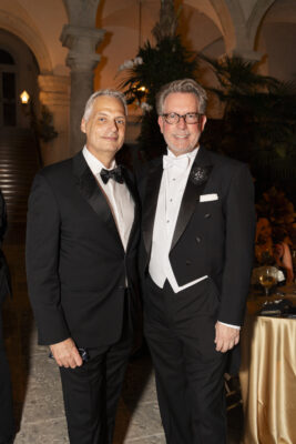 Two men in tuxedos standing next to each other at the Vizcaya Ball.
