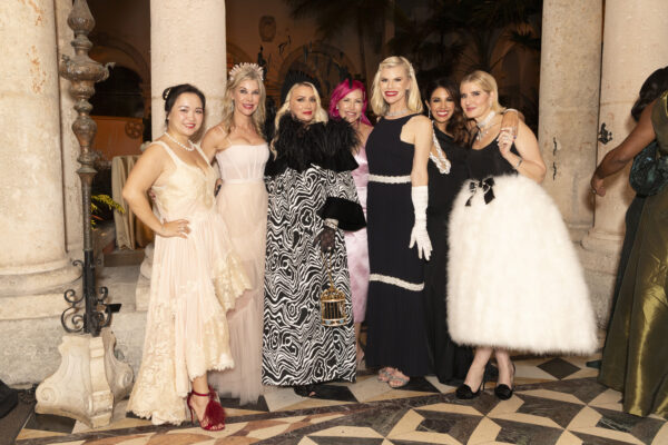 A group of women in formal dresses posing for a photo at the Vizcaya Ball.