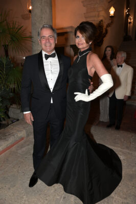 A woman in a black dress and a man in a tuxedo posing at the Vizcaya Ball.