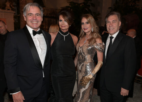 Four people posing for a picture at the Vizcaya Ball, a formal event.
