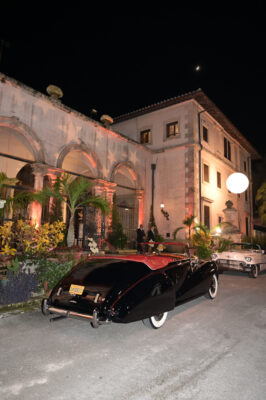 A black car parked in front of the Vizcaya Ball building.