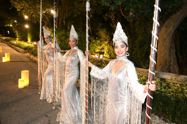 A group of dancers in silver costumes gracefully perform with poles at the Vizcaya Ball.