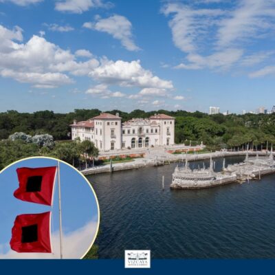 A large historic mansion with waterfront views and surrounding greenery; inset shows two red warning flags with black squares.