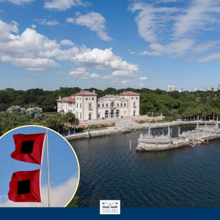A large historic mansion with waterfront views and surrounding greenery; inset shows two red warning flags with black squares.